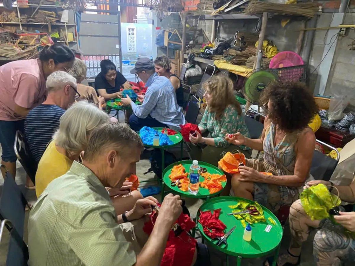Small group of travellers making lanterns in a Hoi An workshop