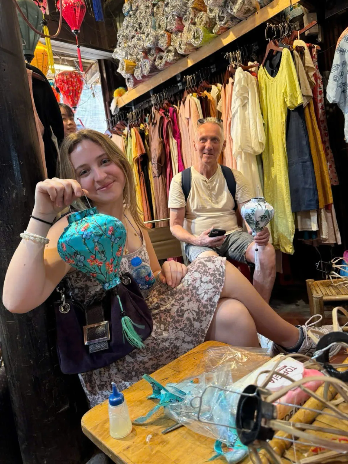 Tourist painting her own silk lantern at a Hoi An lantern making class